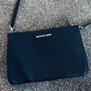 Michael Kors three pocket crossbody in black.